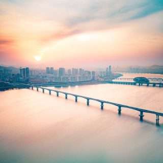 bridge over water near city buildings